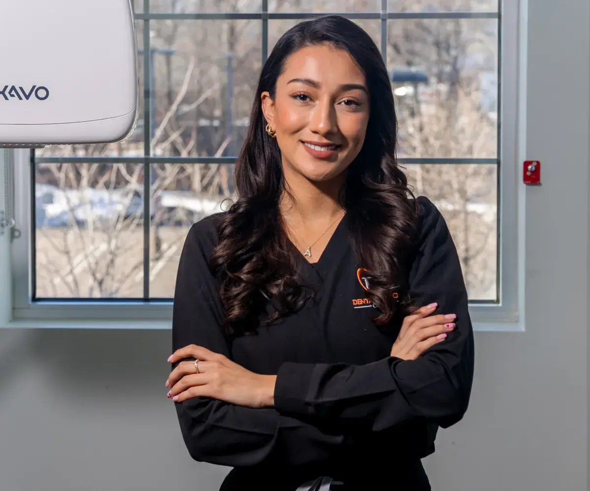 A Lodi team member standing beside dental imaging equipment.