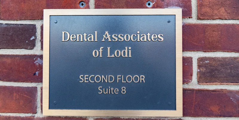 Sign for Dental Associates of Lodi, located on the second floor.