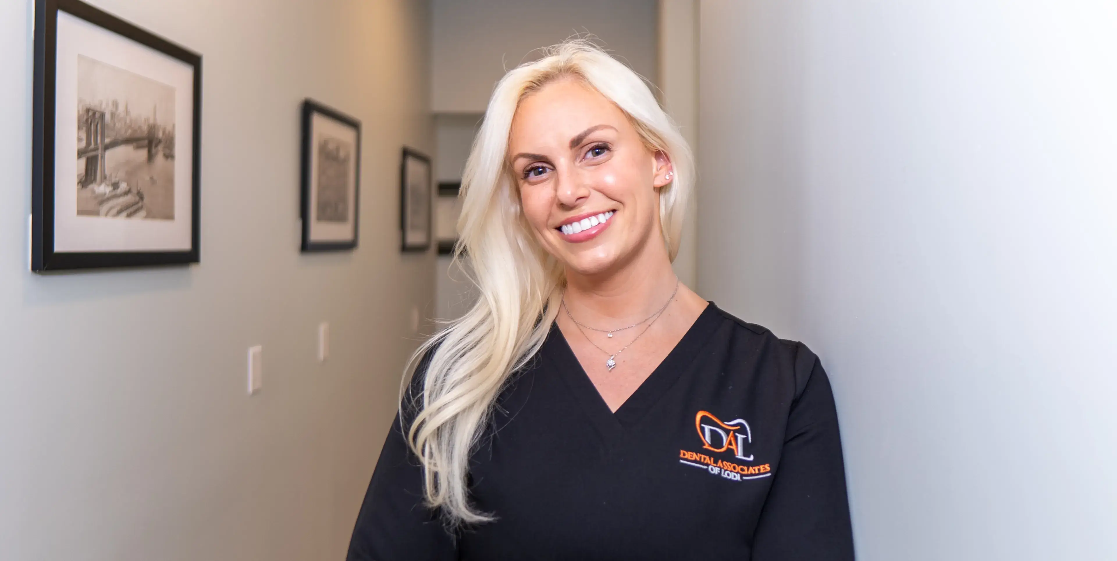 A smiling team member in the office hallway.
