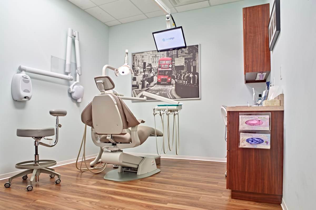 dental exam room with chair and picture of London on wall